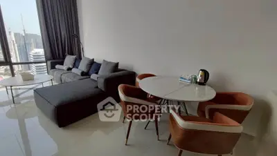 Modern living room with city view, stylish furniture, and natural light.