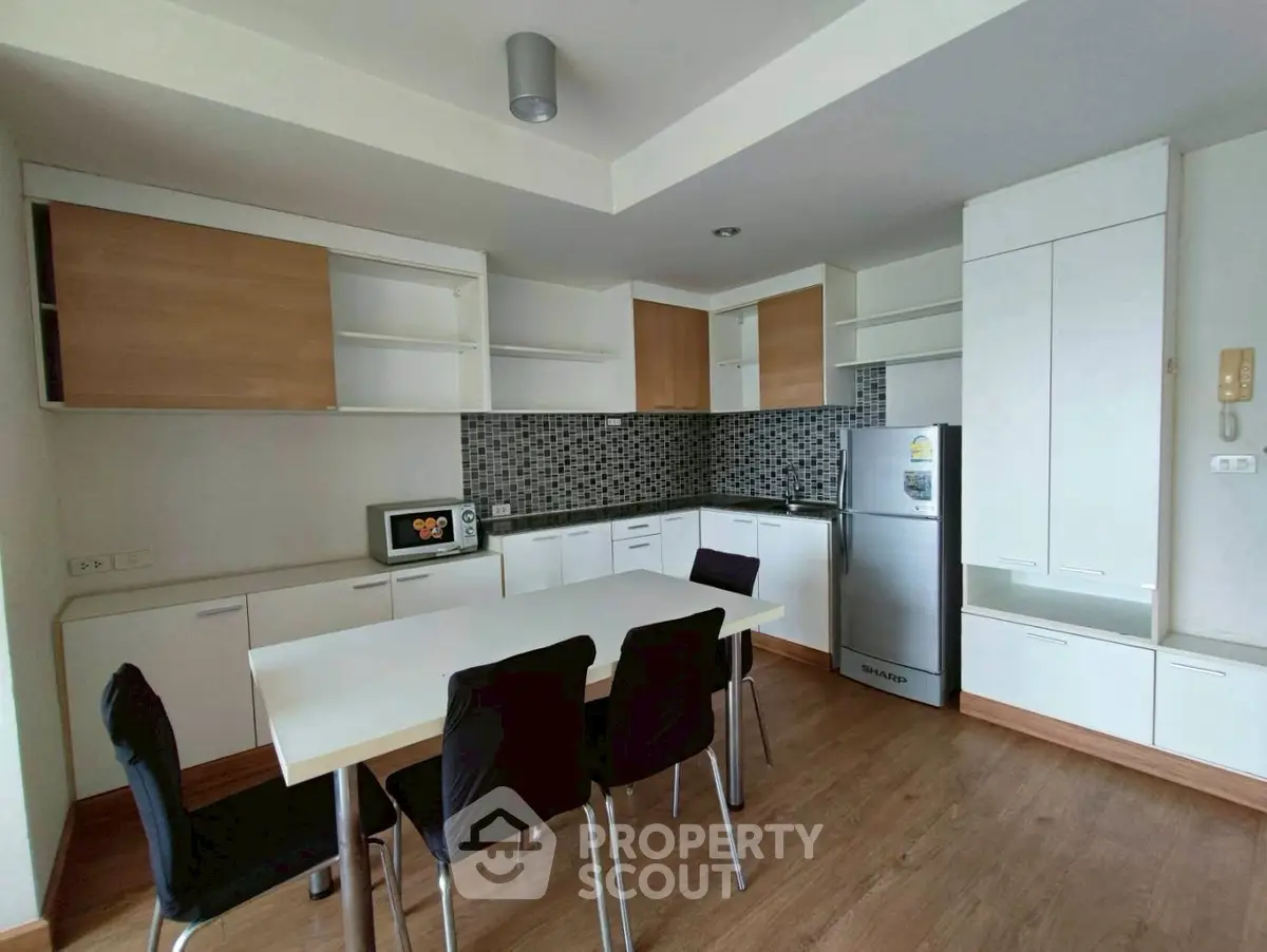 Modern kitchen with sleek cabinets and dining area in open layout