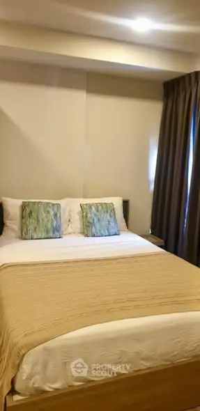 Cozy bedroom with elegant decor and natural light, perfect for relaxation.
