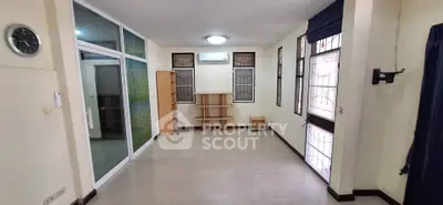Spacious unfurnished room with large windows and tiled flooring, ideal for customization.