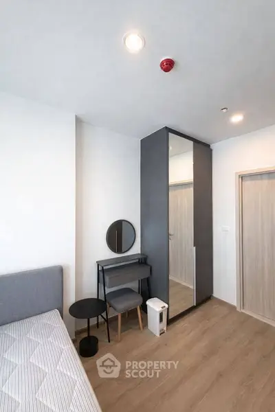 Modern bedroom with sleek wardrobe and minimalist decor