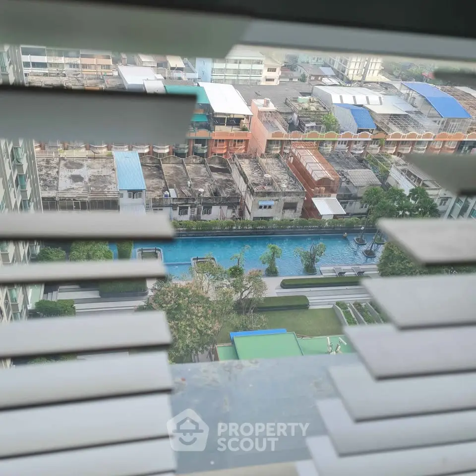 Stunning aerial view of urban landscape with a luxurious pool and lush greenery, perfect for modern living.
