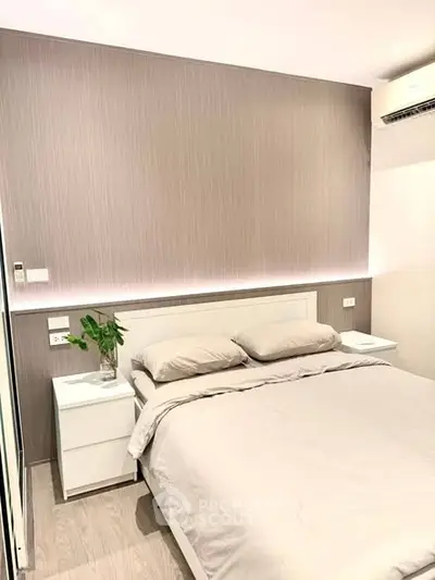 Modern bedroom with sleek design and ambient lighting, featuring a comfortable bed and stylish decor.