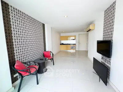 Modern living room with stylish decor and open kitchen layout in a contemporary apartment.