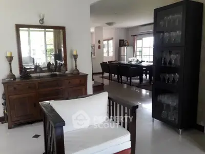 Spacious living room with elegant dining area and glass cabinet