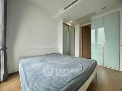 Spacious modern bedroom with large windows and sleek design