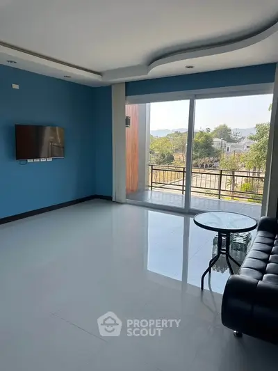 Spacious living room with modern decor and balcony view