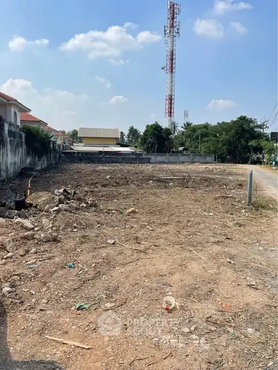 Vacant land plot with clear sky, ideal for development opportunities.