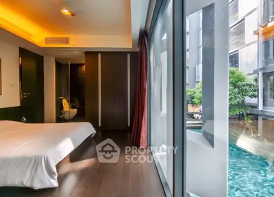 Luxurious bedroom with pool view and modern design