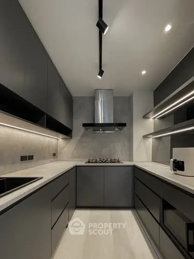 Modern kitchen with sleek black cabinets and gas stove