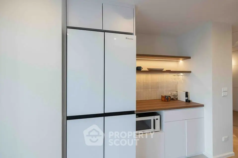 Modern kitchen with sleek white cabinets and built-in appliances