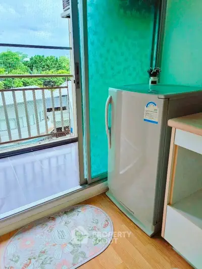 Charming apartment balcony with mini fridge and scenic view, perfect for relaxation and convenience.