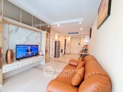 Spacious living room with modern decor and leather sofa in a stylish apartment.