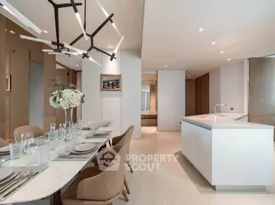 Luxurious modern dining area with elegant lighting and open kitchen layout