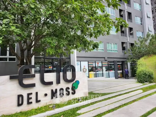 Modern residential building with lush greenery and stylish signage