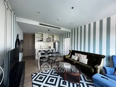 Stylish living room with modern decor and open kitchen layout