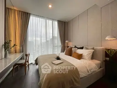 Luxurious modern bedroom with floor-to-ceiling windows and elegant decor in a high-rise apartment.