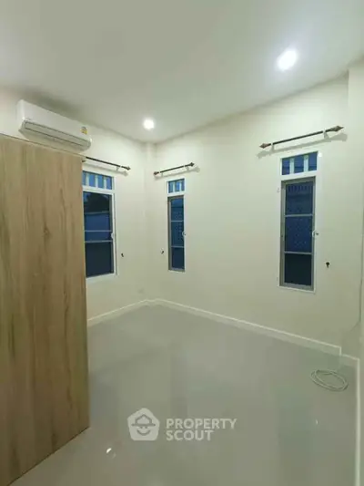 Spacious bedroom with modern air conditioning and sleek flooring