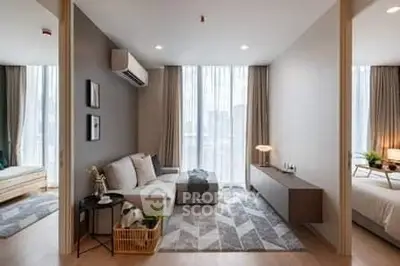 Modern living room with stylish decor and natural light, featuring a cozy sofa and elegant furnishings.