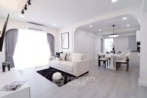 Spacious modern living room with open layout and elegant dining area