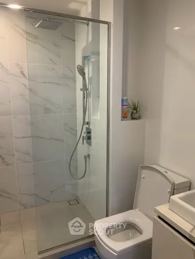 Modern bathroom with glass shower and sleek fixtures