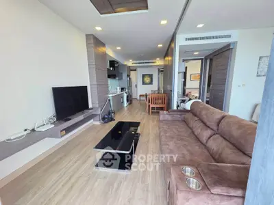 Spacious modern living room with open layout and stylish furnishings in a contemporary apartment.