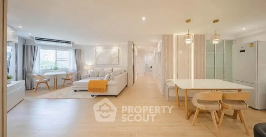 Spacious modern living room with dining area and natural light