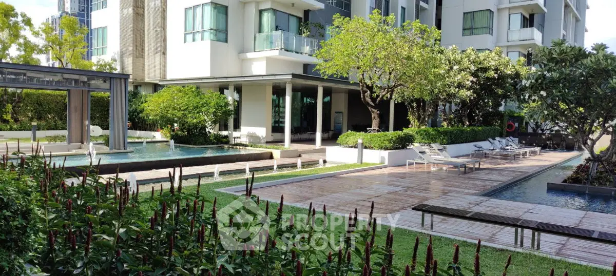 Luxurious condominium exterior with lush garden and inviting pool area, perfect for relaxation and leisure.