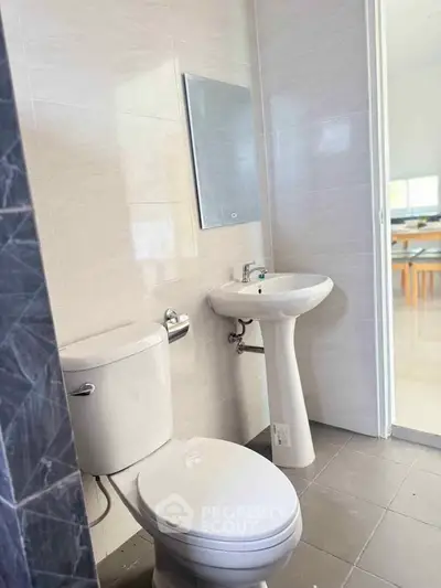 Modern bathroom with sleek fixtures and neutral tiles, perfect for a contemporary home.
