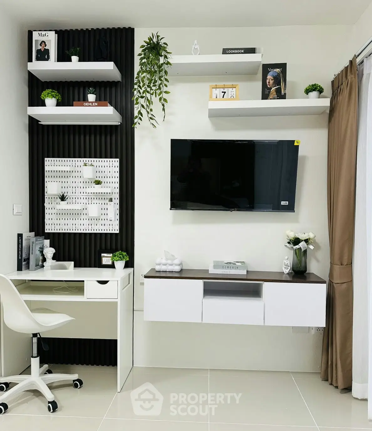 Modern study room with sleek desk, wall-mounted TV, and stylish shelving.