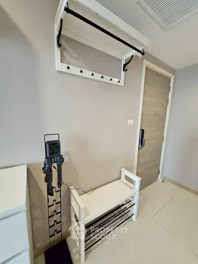 Modern entryway with sleek shoe rack and coat hanger in stylish apartment