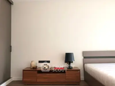 Modern bedroom with sleek wooden furniture and minimalist decor