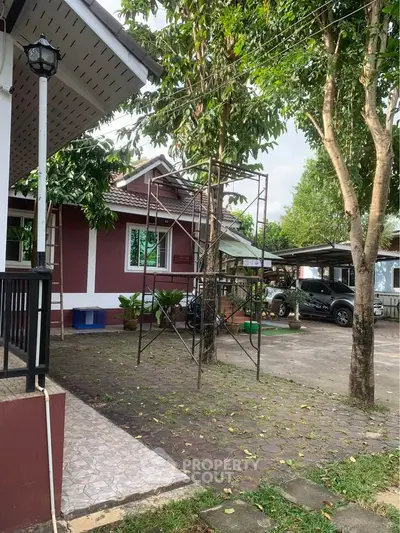 Charming suburban home with lush greenery and spacious driveway, perfect for family living.