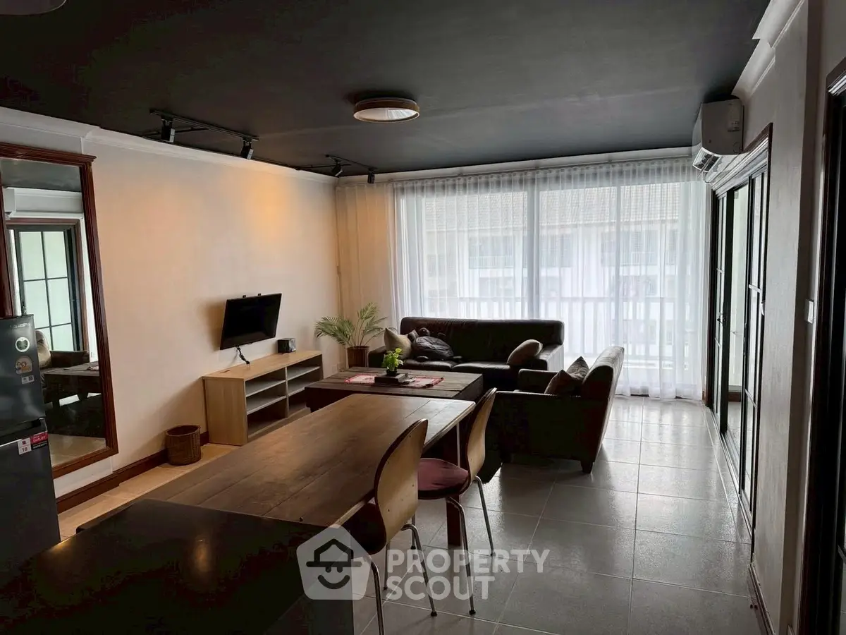 Spacious modern living room with natural light and stylish furniture