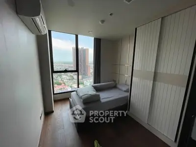 Modern bedroom with city view and sleek wardrobe design.