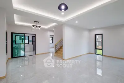 Spacious modern living room with elegant lighting and glossy flooring