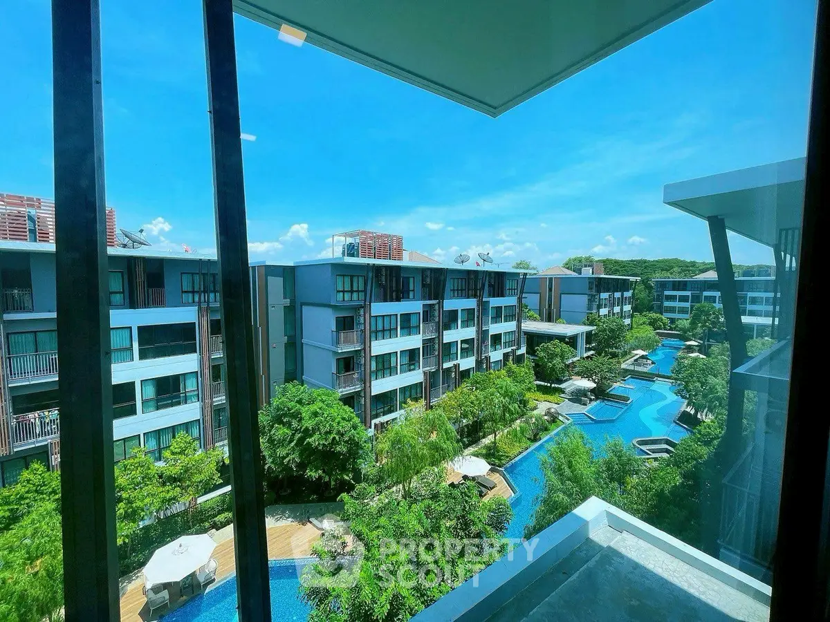 Luxurious condo with stunning pool view and lush greenery, perfect for modern living.