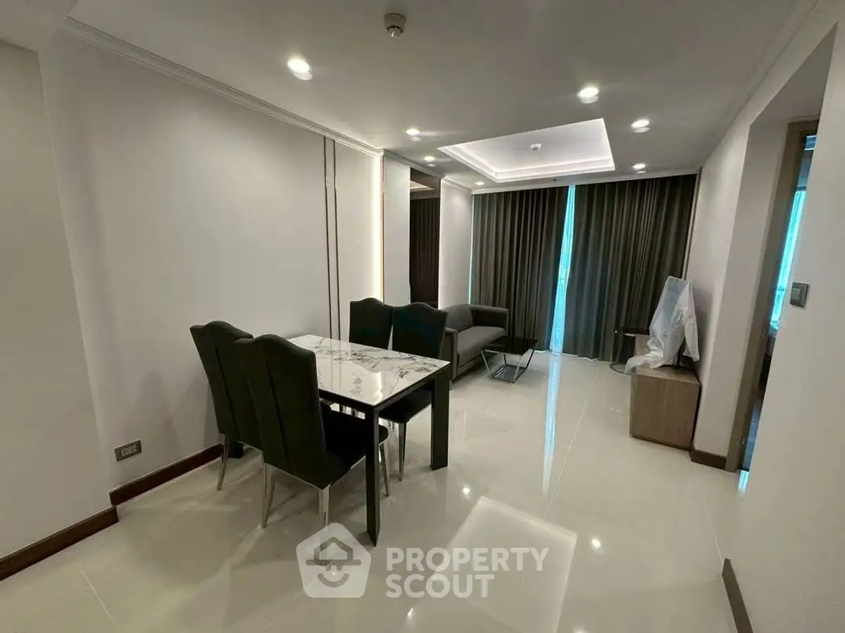 Modern living room with elegant dining area and stylish furnishings.