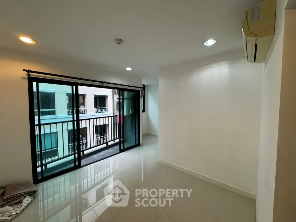 Spacious living room with balcony access in modern apartment