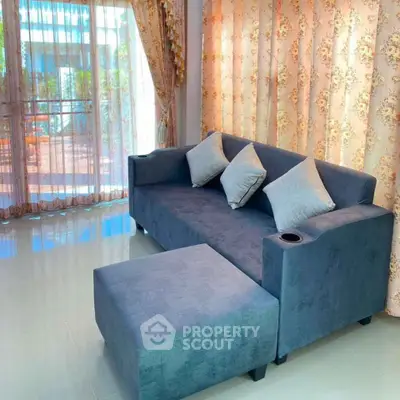 Cozy living room with stylish blue sofa and elegant curtains