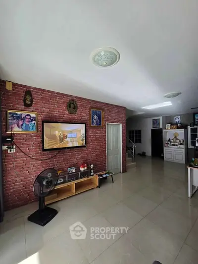Spacious living room with brick accent wall and modern decor