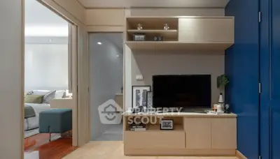 Modern living room with sleek TV unit and cozy bedroom view