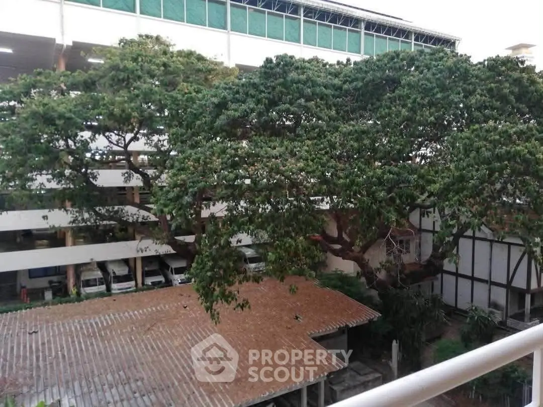 Spacious outdoor view with lush greenery and building exterior, perfect for nature lovers.