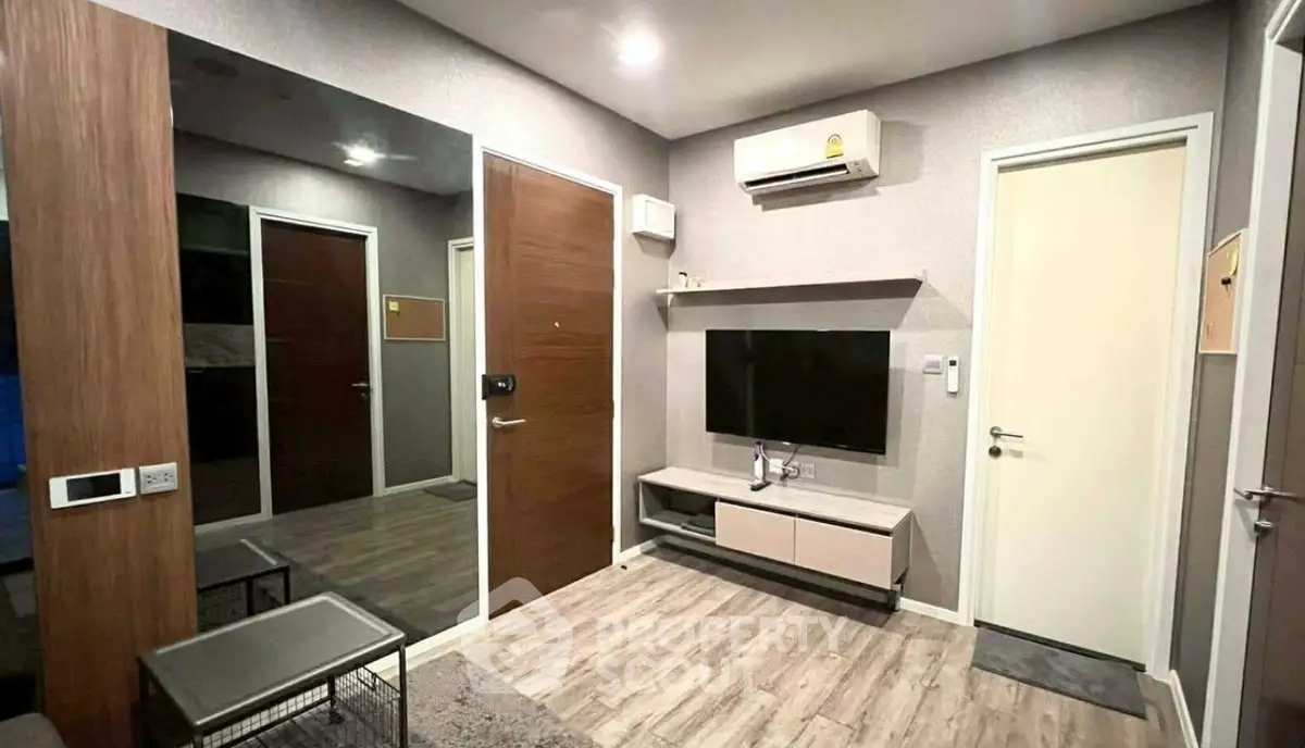 Modern living room with sleek design, featuring wall-mounted TV and air conditioning, perfect for urban living.