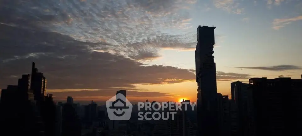Stunning city skyline at sunset with modern skyscrapers and dramatic clouds.