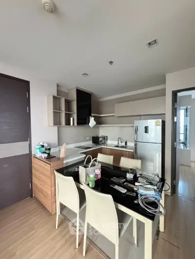 Modern kitchen with sleek design and dining area in a stylish apartment