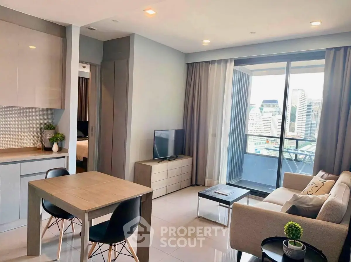 Modern living room with city view, stylish furniture, and open layout in a high-rise apartment.