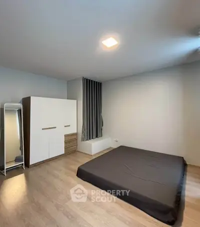 Spacious minimalist bedroom with modern wardrobe and floor mattress