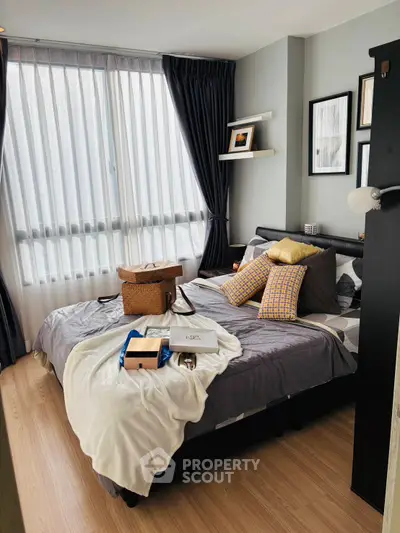 Cozy bedroom with modern decor and large window for natural light