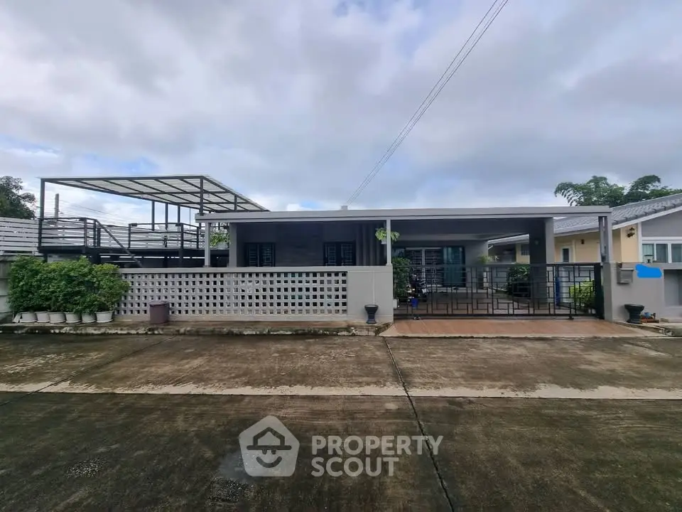 Modern single-story home with spacious driveway and sleek exterior design.